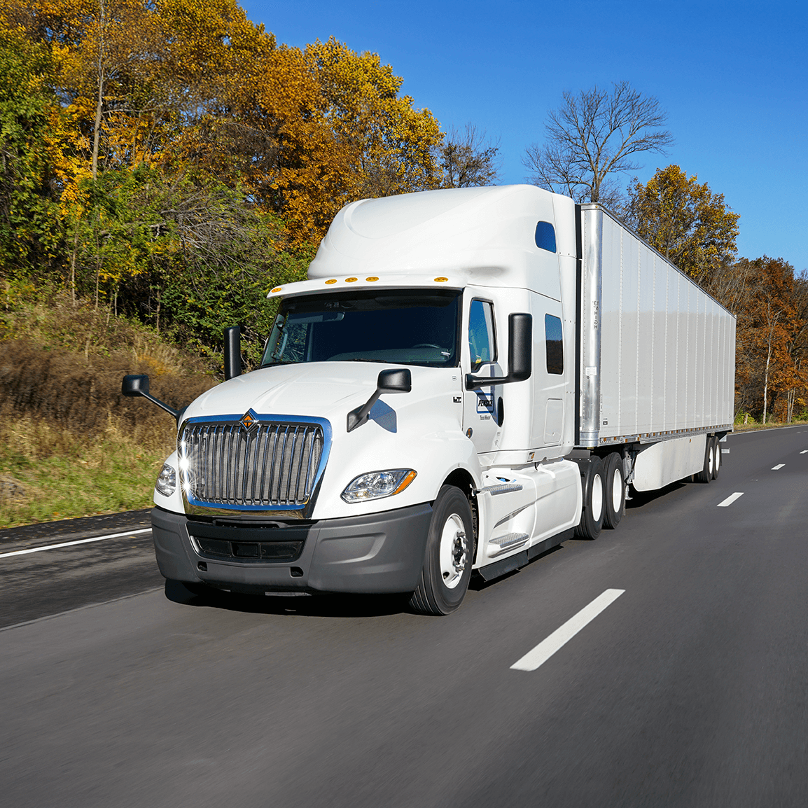 White Penske tractor trailer on the road